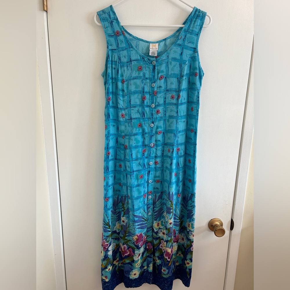Mantles blue dress with floral print, sleeveless, full button up. Slits on side